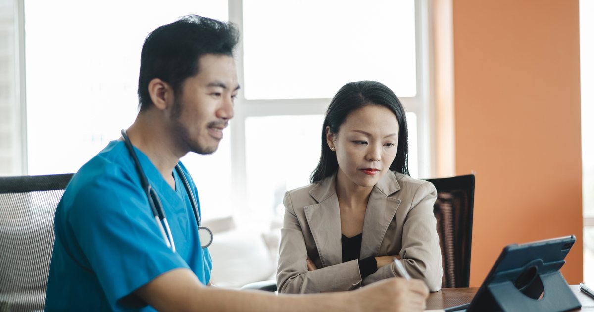 A clinician and an office manager reviewing options together on a tablet